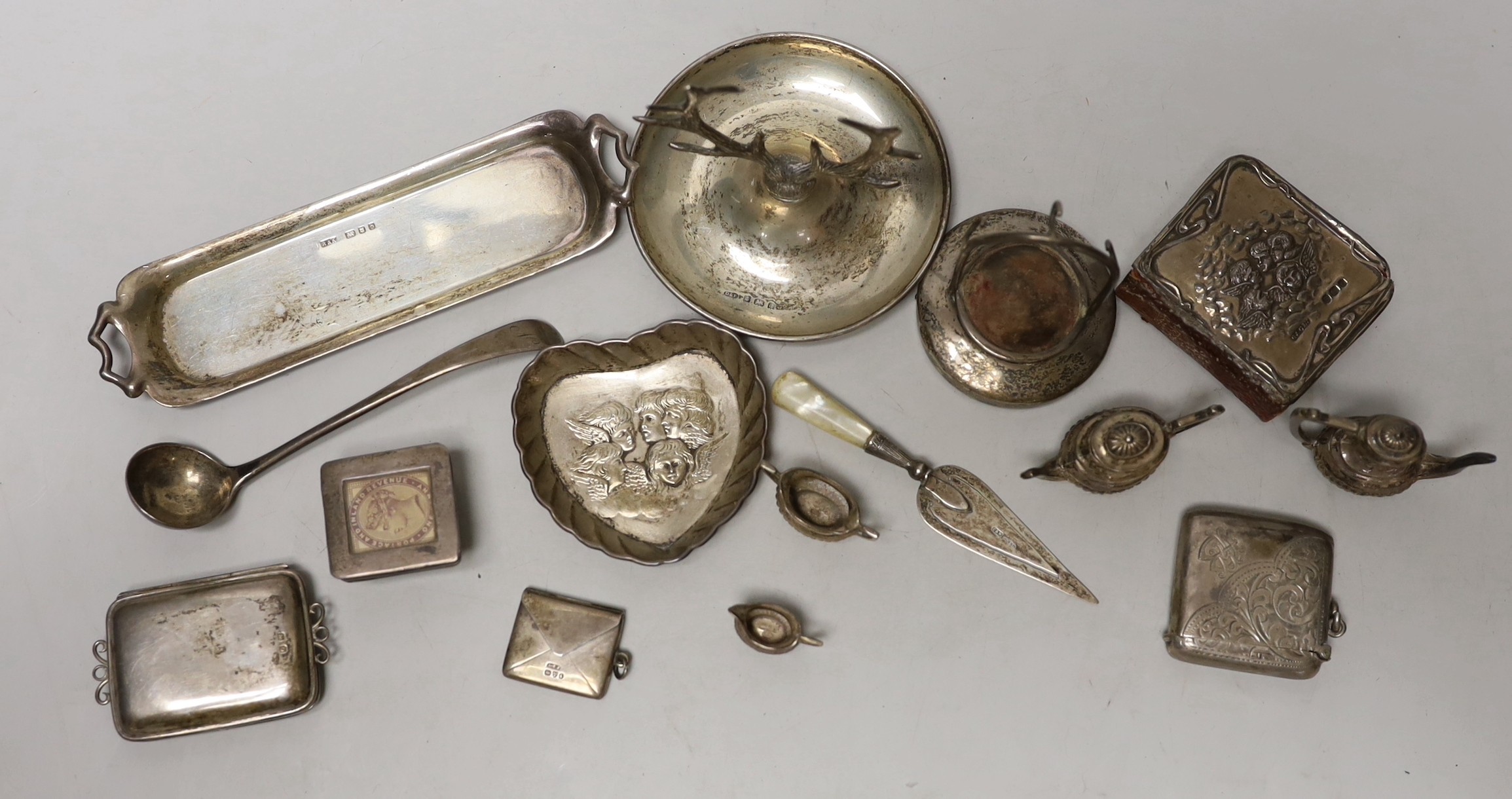 A small quantity of sundry collectable silver including a modern miniature four piece tea set of tray, a watch stand and ring tree, two stamp boxes, mounted bible, vesta case, one other case, a bookmark, dish and mustard